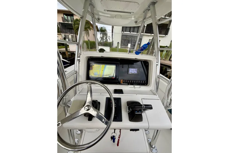 Ribeye Yacht Photos Pics 2005 Jupiter 31 Center Console boat dashboard with steering wheel and navigation system.