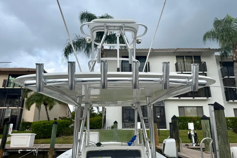 Ribeye Yacht Photos Pics 2005 Jupiter 31 Center Console boat with rod holders, docked near waterfront homes.