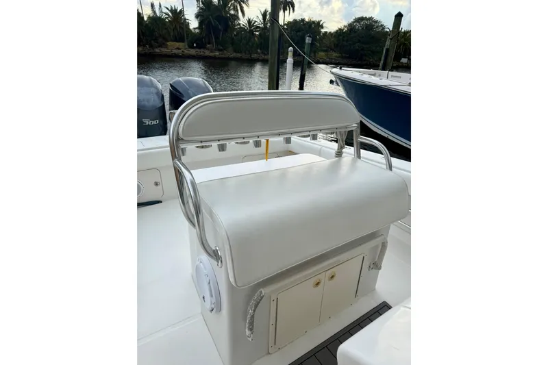 Ribeye Yacht Photos Pics 2005 Jupiter 31 Center Console boat interior with seating and storage, docked by a scenic waterway.