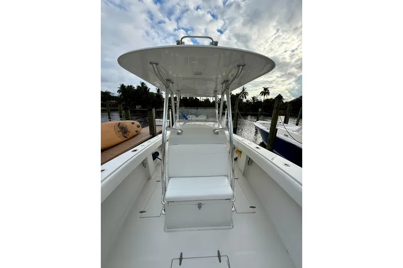 Ribeye Yacht Photos Pics 2005 Jupiter 31 Center Console boat docked, featuring a sleek white design and spacious seating.