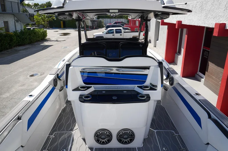 Never Enough Yacht Photos Pics 2023 Sunsation 32 CCX boat interior with blue accents and modern design features.