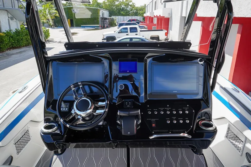 Never Enough Yacht Photos Pics 2023 Sunsation 32 CCX boat dashboard with dual screens and modern controls.