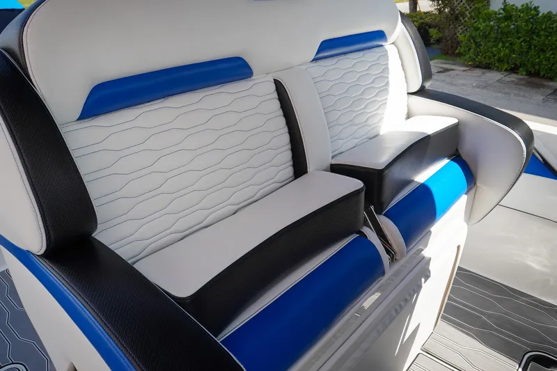 Never Enough Yacht Photos Pics 2023 Sunsation 32 CCX boat interior with blue and white cushioned seating.