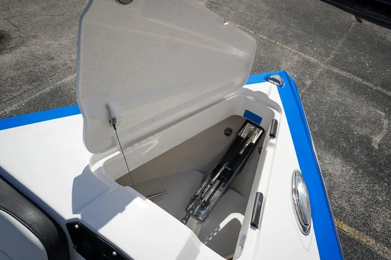 Never Enough Yacht Photos Pics Open storage compartment on 2023 Sunsation 32 CCX boat, featuring blue and white design.