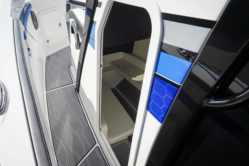 Never Enough Yacht Photos Pics 2023 Sunsation 32 CCX interior with modern design and blue accents.