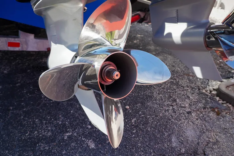 Never Enough Yacht Photos Pics Close-up of a 2023 Sunsation 32 CCX boat propeller, shiny and metallic.