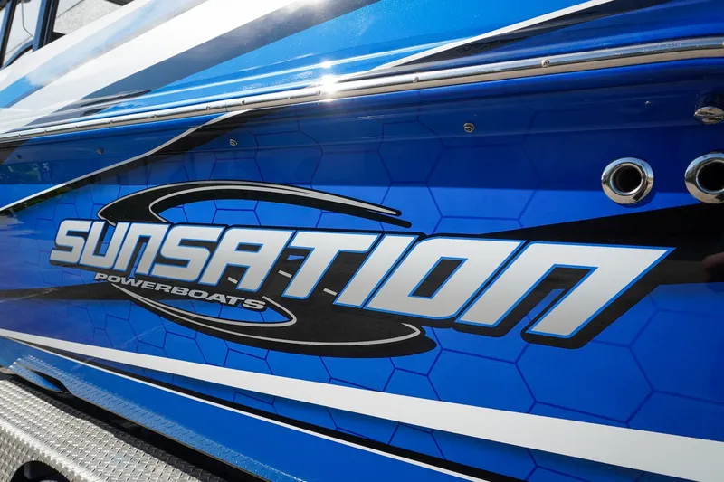 Never Enough Yacht Photos Pics 2023 Sunsation 32 CCX powerboat with blue and white graphics.