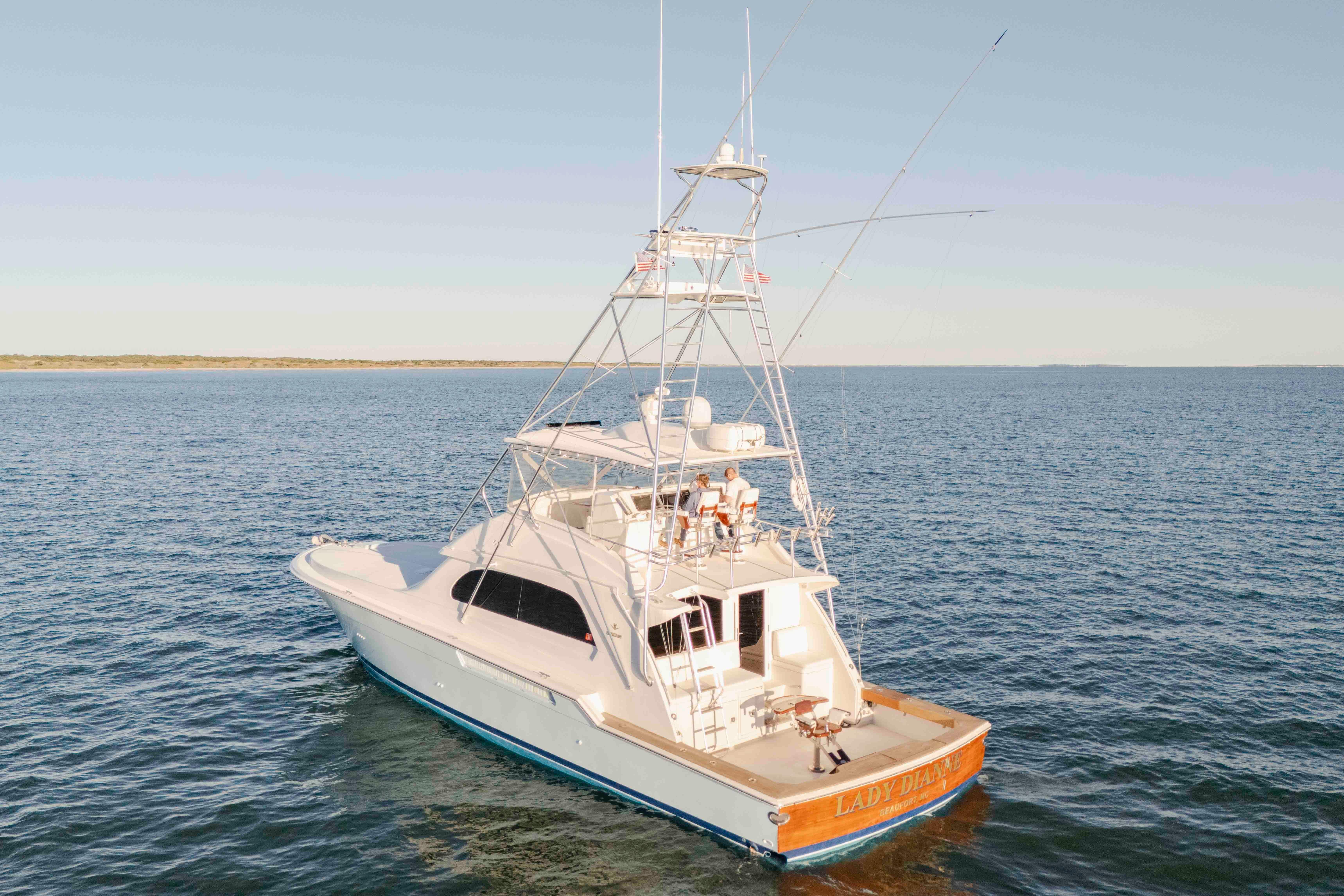 1999 Bertram 60 Convertible yacht on open water, clear sky, rear view.