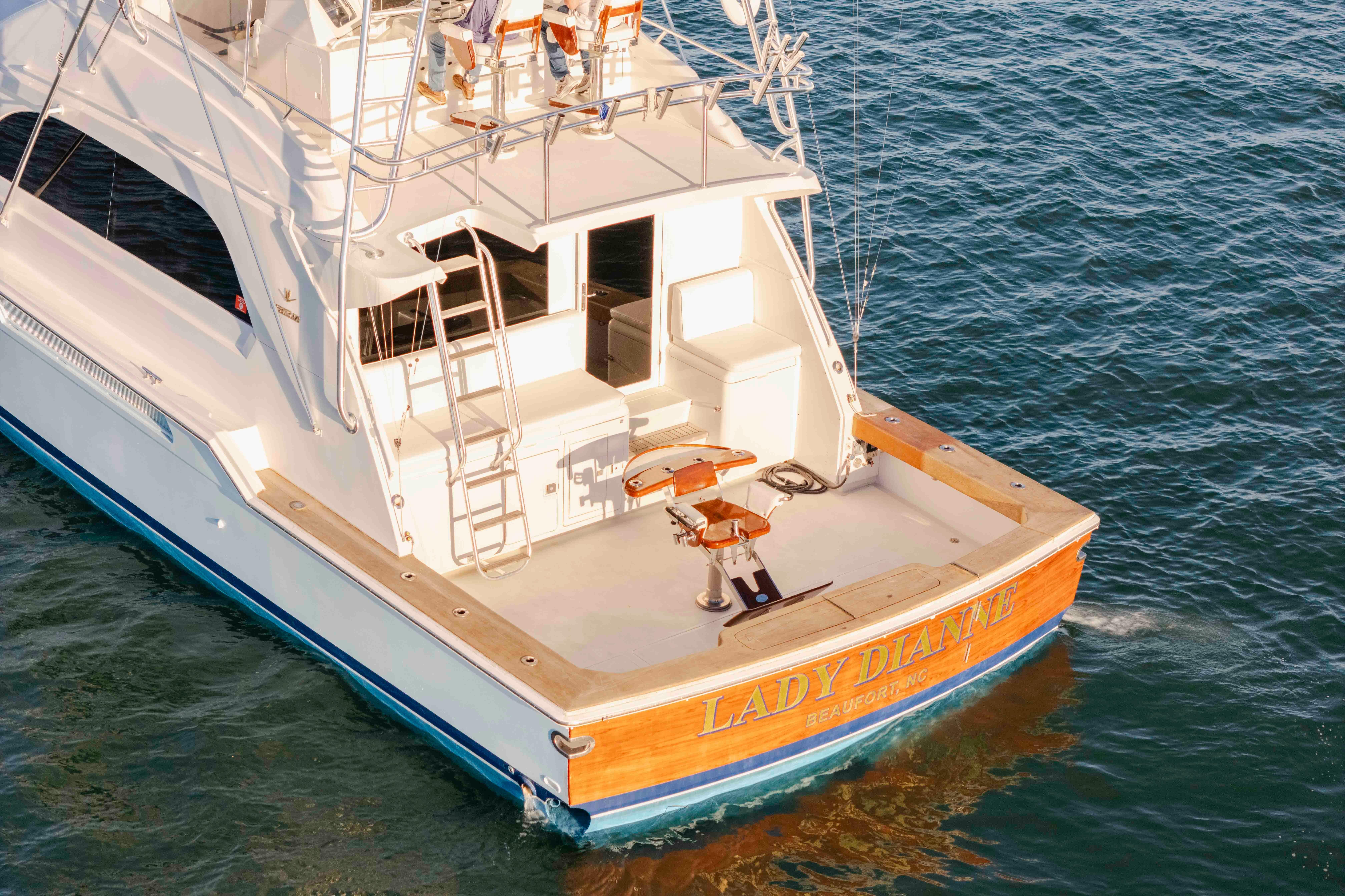 1999 Bertram 60 Convertible yacht on water, rear view, named "Lady Dianne."