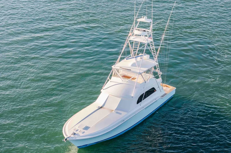 Lady Dianne Yacht Photos Pics 1999 Bertram 60 Convertible yacht on calm blue water, aerial view.