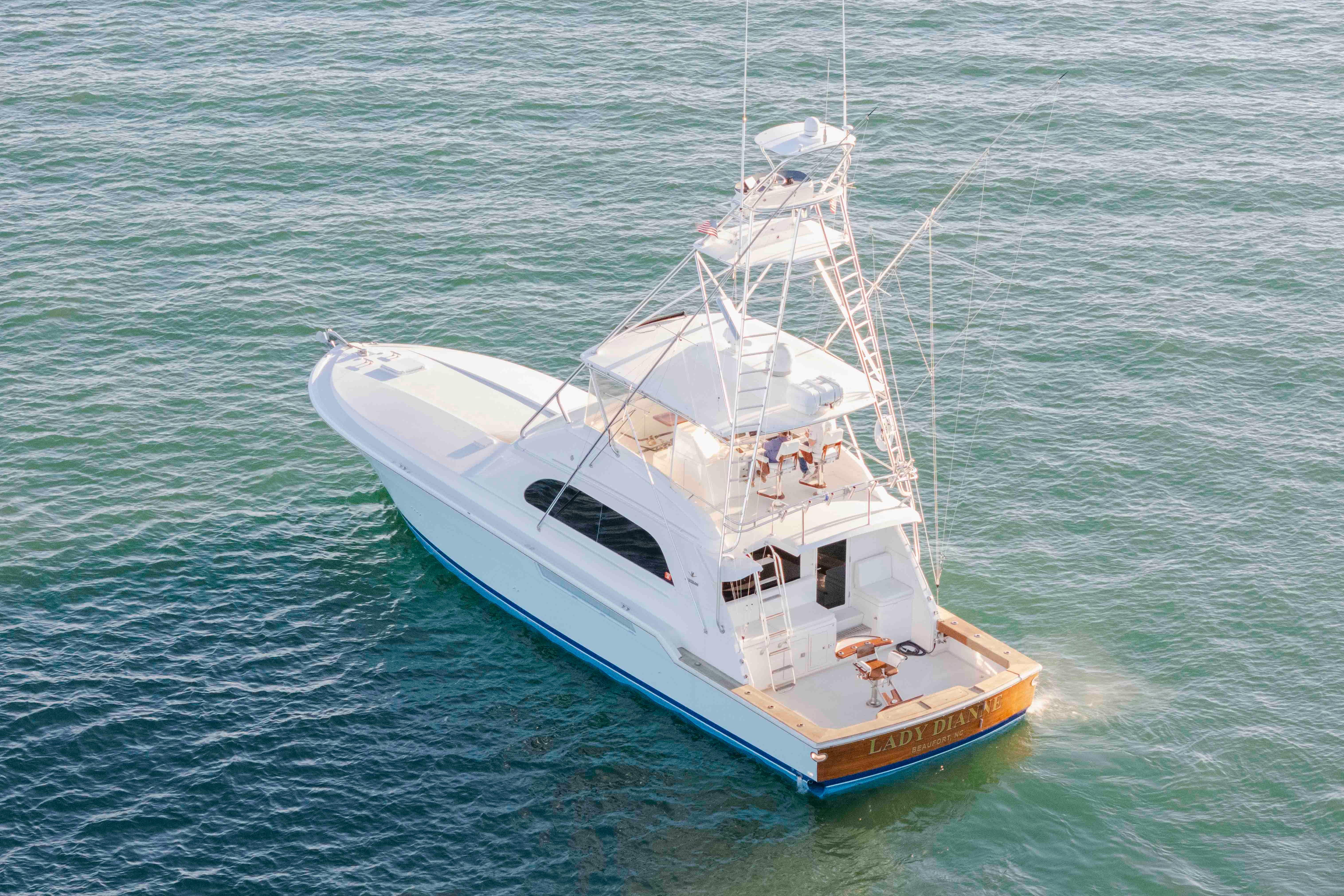 1999 Bertram 60 Convertible yacht cruising on open water.