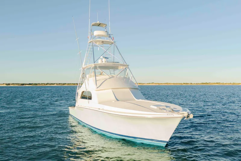 Lady Dianne Yacht Photos Pics 1999 Bertram 60 Convertible yacht on calm blue waters under clear sky.