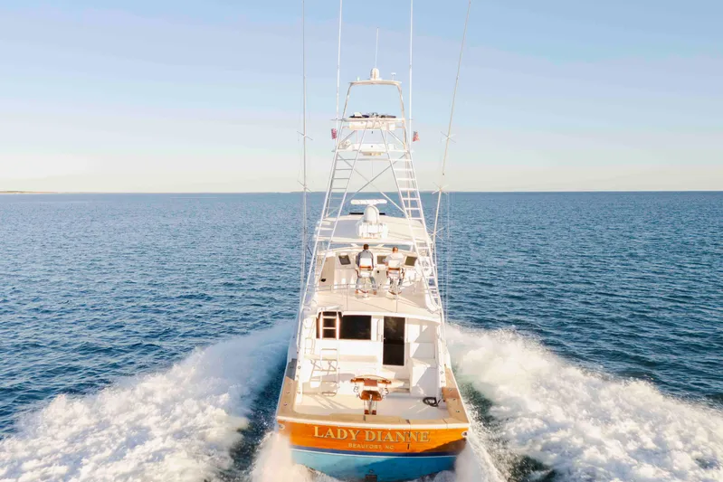 Lady Dianne Yacht Photos Pics 1999 Bertram 60 Convertible yacht cruising on open sea, rear view.