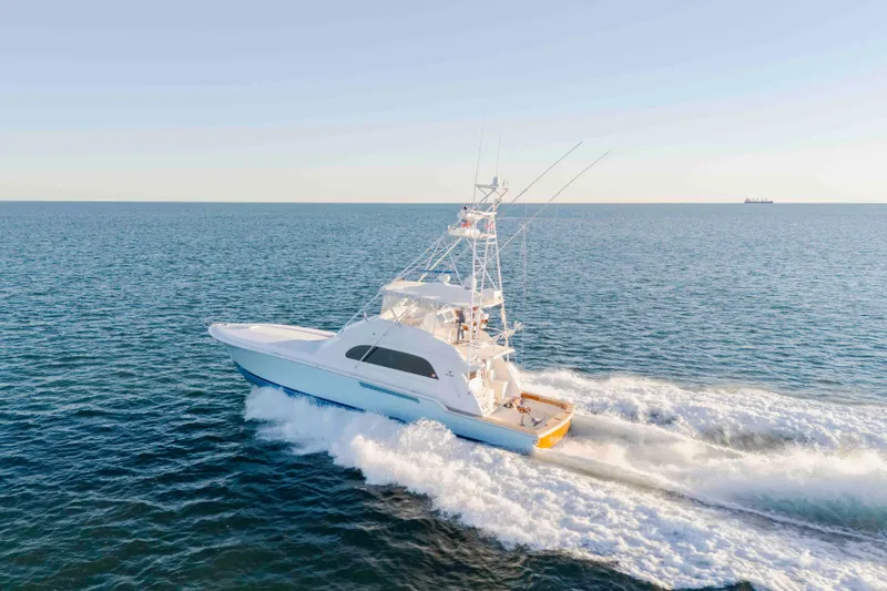 Lady Dianne Yacht Photos Pics 1999 Bertram 60 Convertible yacht cruising on open sea under clear sky.