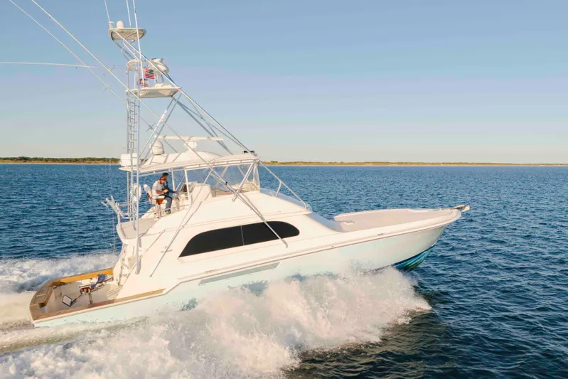 Lady Dianne Yacht Photos Pics 1999 Bertram 60 Convertible yacht cruising on open water under clear skies.