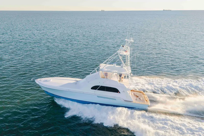 Lady Dianne Yacht Photos Pics 1999 Bertram 60 Convertible yacht cruising on open sea, creating white wake.