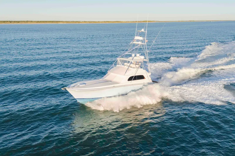 Lady Dianne Yacht Photos Pics 1999 Bertram 60 Convertible yacht cruising on open water, creating a dynamic wake.