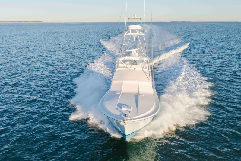 Lady Dianne Yacht Photos Pics 1999 Bertram 60 Convertible yacht cruising on open water, creating a dynamic wake.