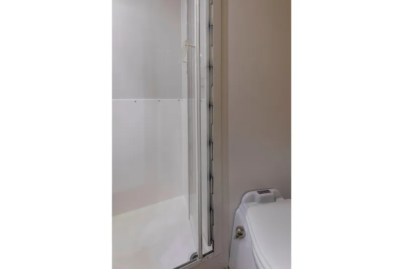 Lady Dianne Yacht Photos Pics Bathroom interior of 1999 Bertram 60 Convertible yacht, featuring shower and toilet.