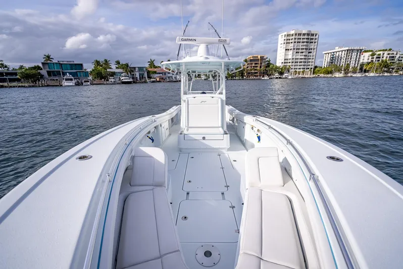  Yacht Photos Pics 2023 Yellowfin 36 boat on water, cityscape background, clear sky.