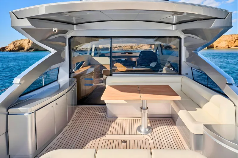 Nickel Yacht Photos Pics Luxurious 2008 Pershing 64 yacht interior with elegant seating and scenic ocean view.