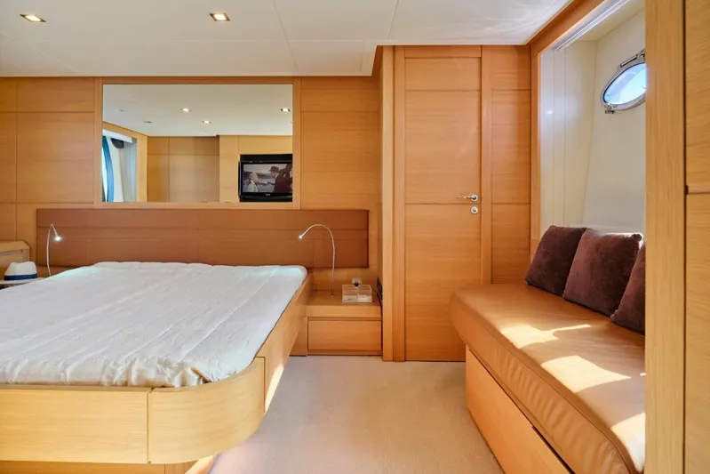 Nickel Yacht Photos Pics Luxurious 2008 Pershing 64 yacht bedroom with modern wood interior and cozy seating area.