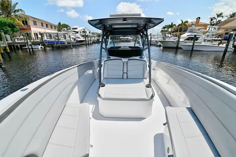  Yacht Photos Pics 2020 Nor-Tech 340 Sport boat with sleek seating, docked in a marina under a clear sky.