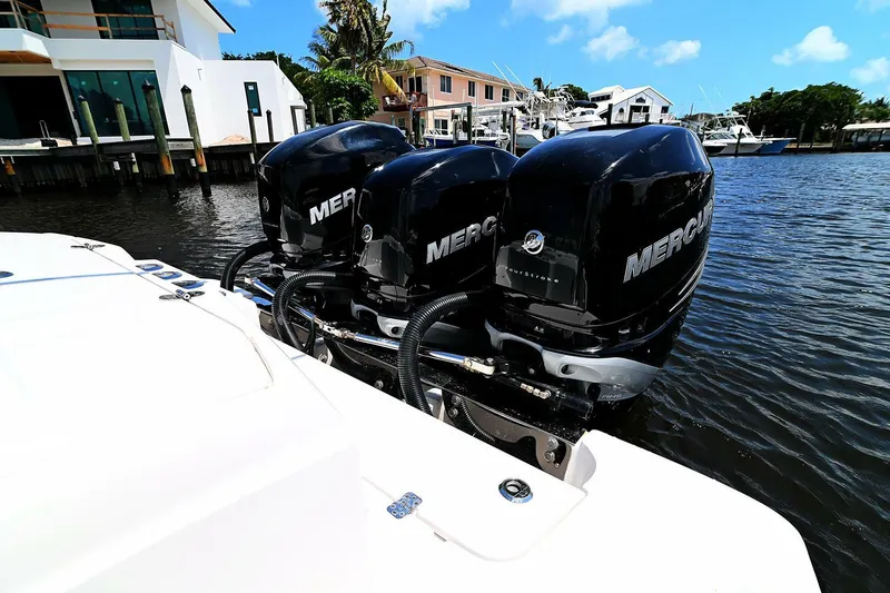  Yacht Photos Pics 2020 Nor-Tech 340 Sport boat with triple Mercury outboard engines docked in a marina.