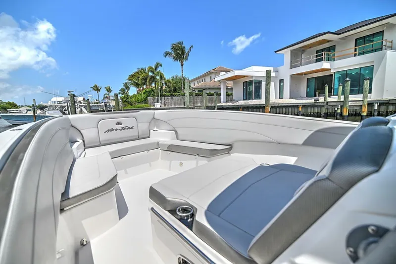  Yacht Photos Pics 2020 Nor-Tech 340 Sport boat with luxurious seating, docked near modern waterfront homes.