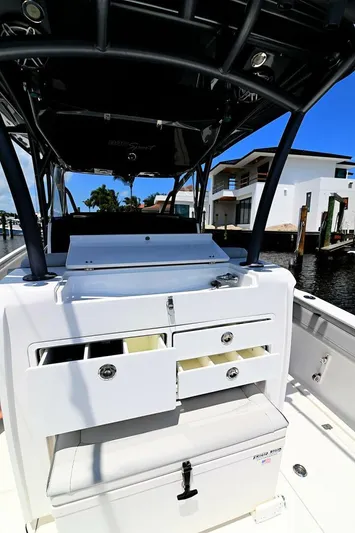  Yacht Photos Pics 2020 Nor-Tech 340 Sport boat with open storage compartments, docked near waterfront homes.