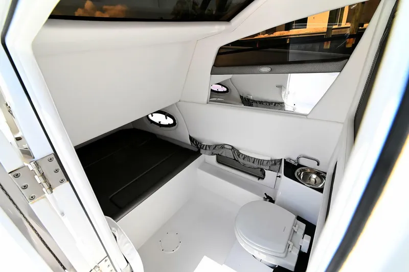  Yacht Photos Pics 2020 Nor-Tech 340 Sport cabin interior with seating and toilet, featuring modern design and amenities.