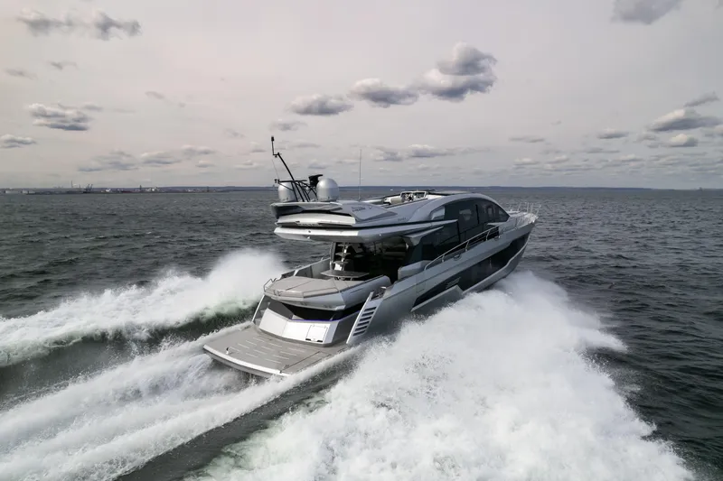 Silver Arrow Yacht Photos Pics 2024 Galeon 700 Sky yacht cruising swiftly on open water under cloudy skies.