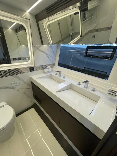 Silver Arrow Yacht Photos Pics Luxurious bathroom in 2024 Galeon 700 Sky yacht with dual sinks and modern fixtures.