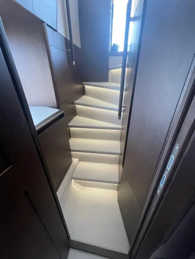 Silver Arrow Yacht Photos Pics Staircase inside 2024 Galeon 700 Sky yacht, featuring modern design and ambient lighting.