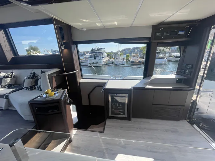 Silver Arrow Yacht Photos Pics Luxurious interior of 2024 Galeon 700 Sky yacht with modern furnishings and marina view.