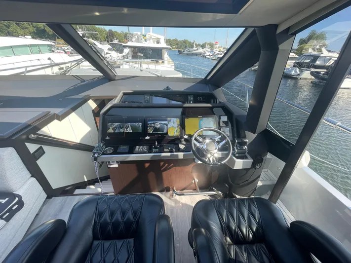 Silver Arrow Yacht Photos Pics 2024 Galeon 700 Sky yacht cockpit with modern controls and leather seating.