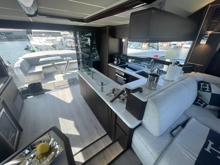 Silver Arrow Yacht Photos Pics Luxurious interior of 2024 Galeon 700 Sky yacht with modern kitchen and seating area.