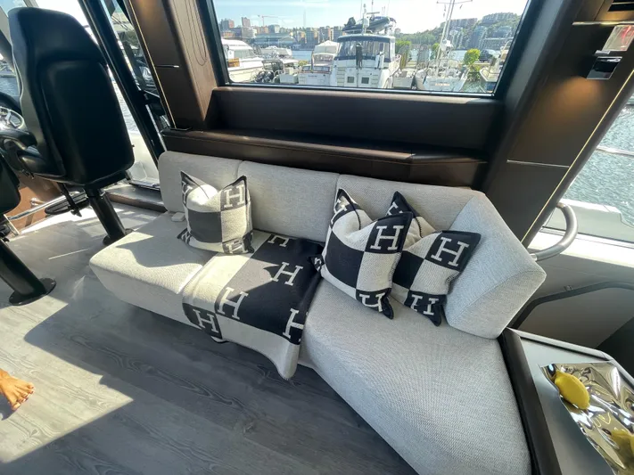 Silver Arrow Yacht Photos Pics Luxurious interior of 2024 Galeon 700 Sky yacht with stylish cushions and marina view.