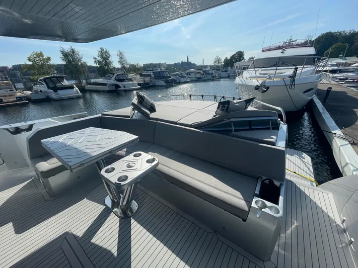 Silver Arrow Yacht Photos Pics 2024 Galeon 700 Sky yacht with sleek deck seating, docked in a marina.