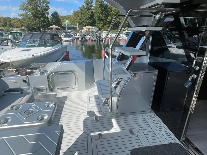 Silver Arrow Yacht Photos Pics 2024 Galeon 700 Sky yacht deck with modern seating and sleek design in a marina setting.