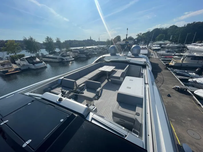 Silver Arrow Yacht Photos Pics Luxurious 2024 Galeon 700 Sky yacht docked at a marina under a clear blue sky.