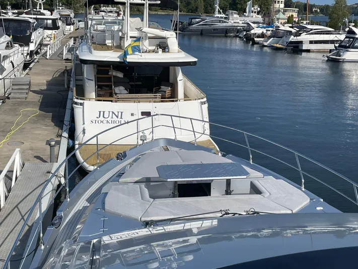 Silver Arrow Yacht Photos Pics 2024 Galeon 700 Sky yacht docked in a marina, with other boats nearby.