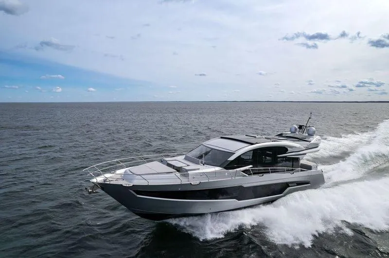Silver Arrow Yacht Photos Pics 2024 Galeon 700 Sky yacht cruising on open water under a partly cloudy sky.