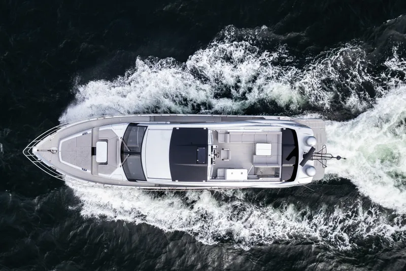 Silver Arrow Yacht Photos Pics Aerial view of 2024 Galeon 700 Sky yacht cruising through water.