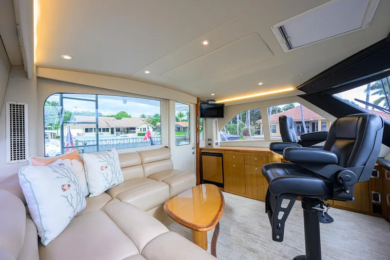  Yacht Photos Pics Luxurious interior of 2008 Viking 56 Enclosed Bridge yacht with leather seating and panoramic windows.