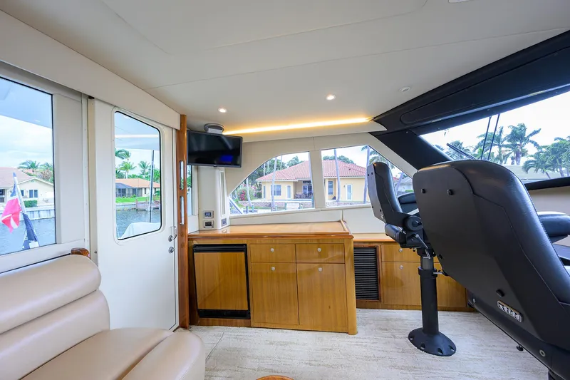  Yacht Photos Pics Luxurious interior of 2008 Viking 56 Enclosed Bridge yacht with modern helm and seating.