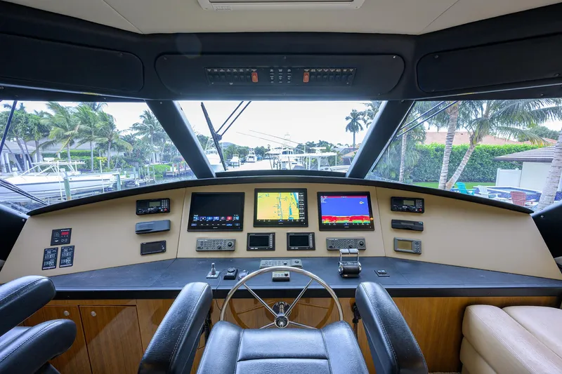  Yacht Photos Pics 2008 Viking 56 Enclosed Bridge yacht helm with navigation screens and steering wheel.