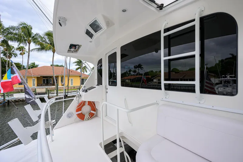  Yacht Photos Pics 2008 Viking 56 Enclosed Bridge yacht deck with seating, ladder, and life preserver.