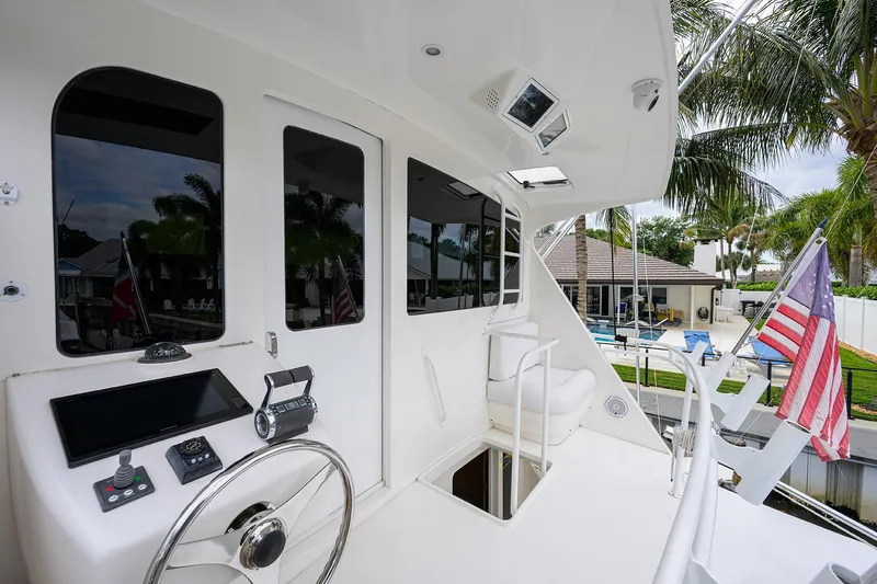  Yacht Photos Pics 2008 Viking 56 Enclosed Bridge yacht with helm, American flag, and tropical surroundings.