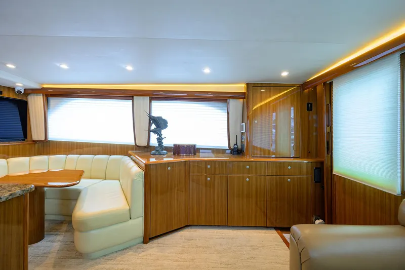  Yacht Photos Pics Luxurious interior of 2008 Viking 56 Enclosed Bridge yacht with elegant wood finishes.